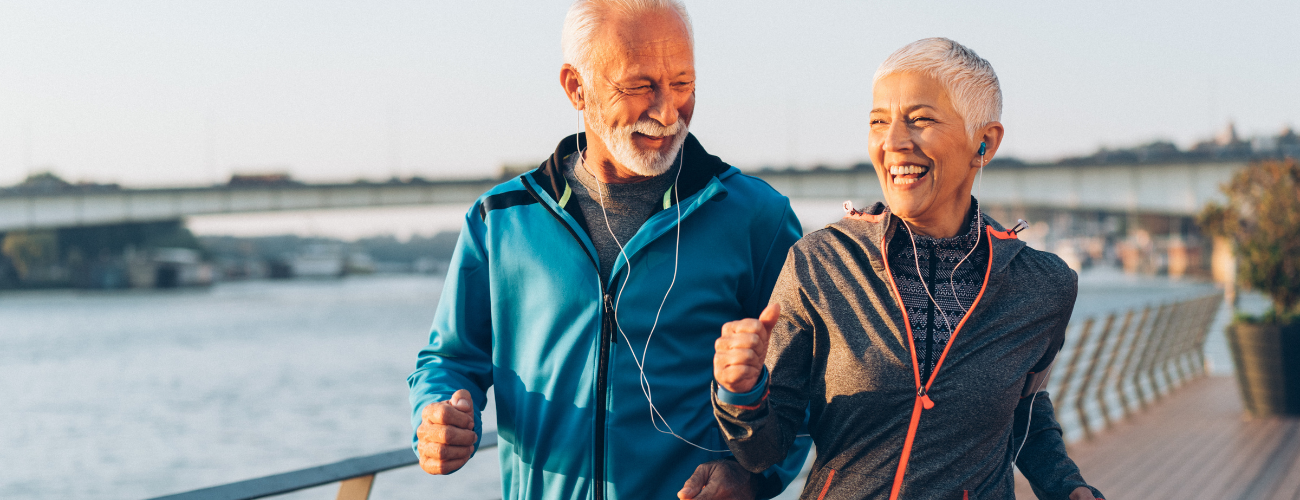 Couple Jogging in Functional Jackets A couple jogging in functional outdoor jackets – breathable, lightweight, and weather-resistant activewear